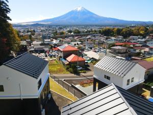 an aerial view of a city with a mountain in the background at Villas Asama no Iori in Fujiyoshida