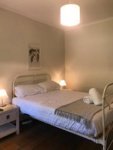 a bedroom with two beds and a table and two lamps at Quamby Homestead in Woolsthorpe