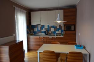 a kitchen with a table and chairs in a room at Apartments Sofija in Bled