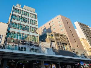 a group of tall buildings in a city at Kyoto Central Inn in Kyoto