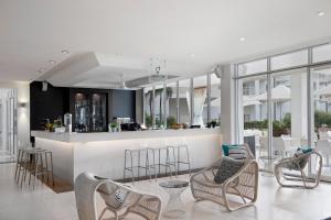 a lobby with chairs and a bar in a building at Mantra on Salt Beach in Kingscliff