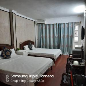 Voodi või voodid majutusasutuse Hanoi Carina Hotel toas