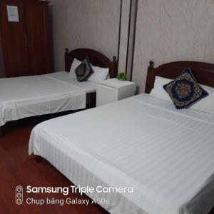 Voodi või voodid majutusasutuse Hanoi Carina Hotel toas