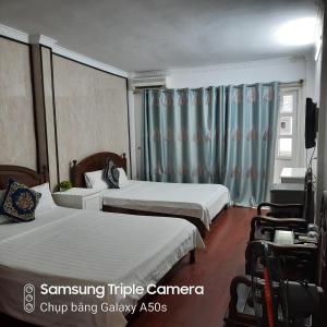 Voodi või voodid majutusasutuse Hanoi Carina Hotel toas