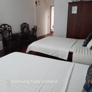 Voodi või voodid majutusasutuse Hanoi Carina Hotel toas