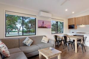 a living room with a couch and a table at Discovery Parks - Pambula Beach in Pambula