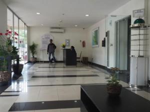 a man standing in a lobby of a building at Sewaunitkalcit in Jakarta