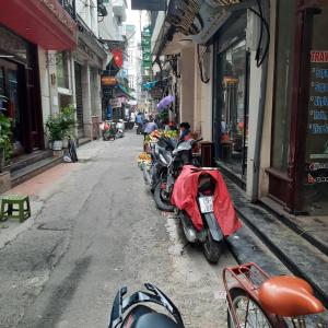 a row of motorcycles parked on the side of a street at Hanoi Carina Hotel in Hanoi