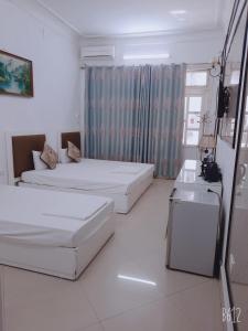 Voodi või voodid majutusasutuse Hanoi Carina Hotel toas