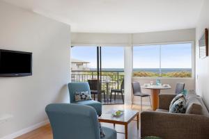 a living room with a couch and chairs at Mantra on Salt Beach in Kingscliff