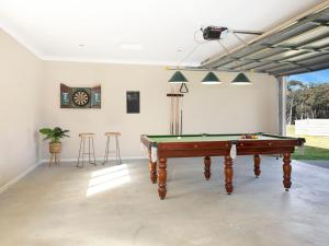 a room with a pool table and a clock on the wall at Newbury Haven in Penrose