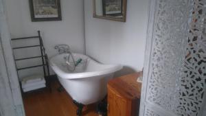 a bathroom with a sink and a bath tub at 29onTait Guest House in Pretoria