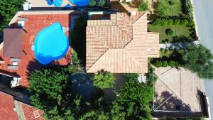 an overhead view of a house with a blue roof at Neriides Villas in Hersonissos