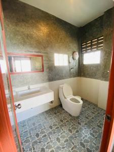 a bathroom with a toilet and a sink and a tub at Phumektawan ภูเมฆตะวัน Hotel&Restaurant in Mae Salong