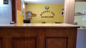 a reception counter in a hospital with a sign on the wall at Budget inn 2000 in Hamilton