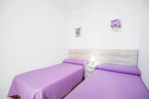 Ein Bett oder Betten in einem Zimmer der Unterkunft Apartamento Conil Centro