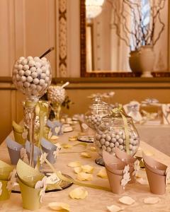 a table with vases and other items on it at Hotel Villa Malpensa in Vizzola Ticino +26 photos