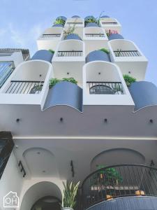 a building with balconies and plants on it at OH FAMILY QUY NHON HOMESTAY in Quy Nhon