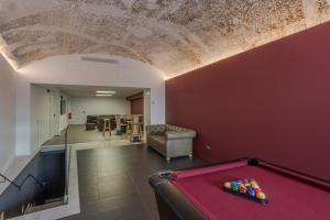 a pool table in a living room with a ceiling at Hotel Olot Centre in Olot