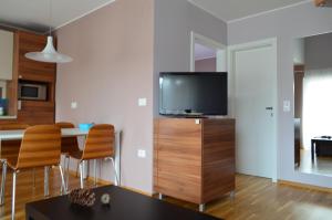 a living room with a television on a wooden dresser at Apartments Sofija in Bled