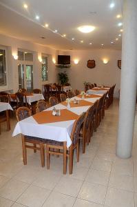 a dining room with tables and chairs in a restaurant at Penzion Jantoľák in Zuberec