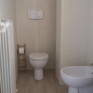 a white bathroom with a toilet and a sink at La Persiana2 in Ancona