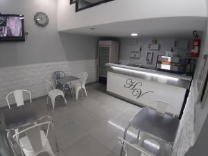 a restaurant with chairs and a table and a counter at Albergo Viola in Naples