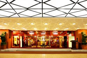 a lobby of a building with lights on the ceiling at The Ambassador, Marine Drive, Mumbai in Mumbai