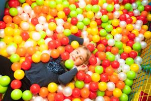 a young boy swimming in a pool of balls at Sport Hotel Vittoria in Passo del Tonale