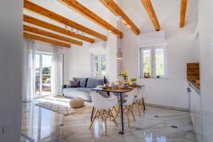 cocina y sala de estar con mesa y sillas en Lučica 360 sea view suite, en Nerezine