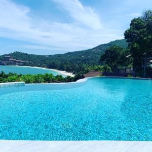 a large swimming pool with a view of the water at High Life Bungalow in Haad Yao