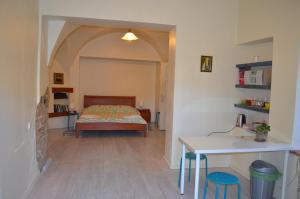 a bedroom with a bed and a table in a room at Vilnius Collegium Apartment in Vilnius