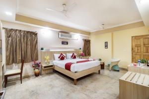 a hotel room with a bed and a bathroom at Octave Royal Opera in Bangalore