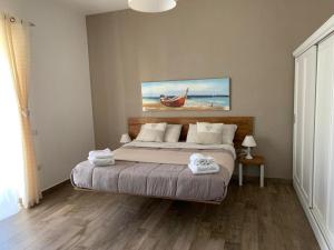 a bedroom with a bed with towels on it at Etesia in Olbia