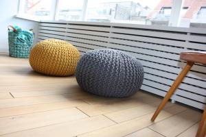 two spheres sitting on the floor of a room at Appartement Knokke, vlakbij het strand en winkels in Knokke-Heist +16 photos