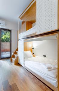 a bedroom with a bunk bed with wooden shelves at The Tbilisi Pod in Tbilisi City
