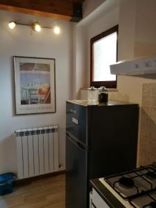 a kitchen with a black refrigerator and a stove at La Persiana2 in Ancona