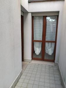 a door with a window with curtains on it at La Persiana2 in Ancona