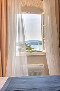 Postel nebo postele na pokoji v ubytování Heritage Hotel Leon Coronato