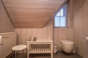 a bathroom with a toilet and a window at Apfelblüte in Lindau +12 photos