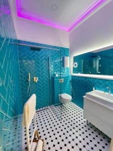 a blue bathroom with a toilet and a sink at Hevals Palace in Berlin