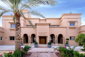 a palm tree in front of a building at Villa Casablanca- Exclusive 7-Bedroom Villa with Signature Amenities By Luxury Explorers' Collection in Dubai