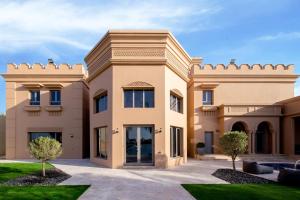a villa in the middle of a yard at Villa Casablanca- Exclusive 7-Bedroom Villa with Signature Amenities By Luxury Explorers' Collection in Dubai