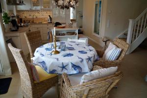 a dining room table with a blue and white table cloth at Ferienhaus Windrose in Breege