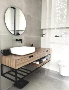 a bathroom with a sink and a mirror at Danielle boutique suite in Caesarea