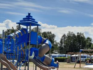 a playground with a slide in a park at Falsterbo Camping Resort in Skanör med Falsterbo