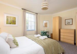 a bedroom with a white bed and a window at Castle Suite 3 Old Town in Edinburgh