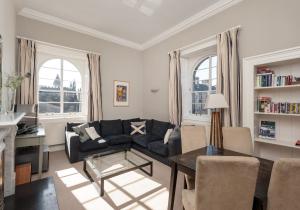 a living room with a couch and a table at Parliament Sq (apt 15) Royal Mile in Edinburgh