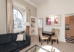 a living room with a couch and a table at Parliament Sq (apt 15) Royal Mile in Edinburgh