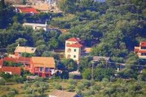 a group of houses on top of a hill at Emily's Apartments in Kassiopi